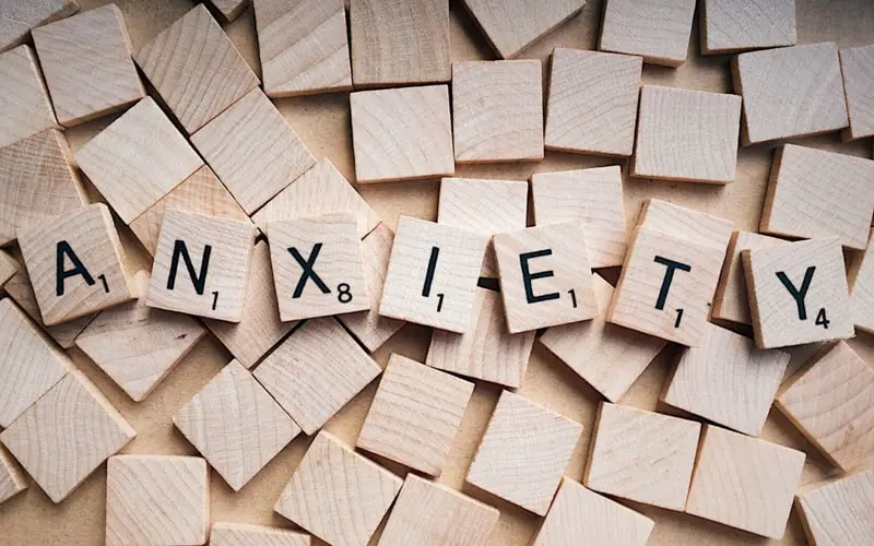 Scrablle Tiles that spell out "ANXIETY"